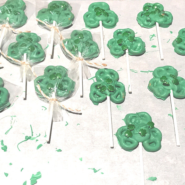 Half of the shamrocks packaged and ready for delivery, half waiting to be wrapped up